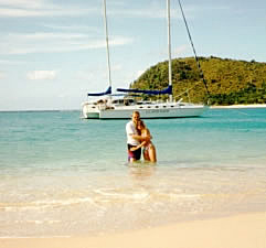 Ken and Darla in the surf with the Grand Oais in the background