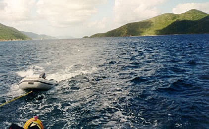The trailing dinghy with islands in the background