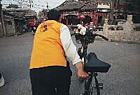 Our rickshaw driver pulling us over the bridge, Beijing