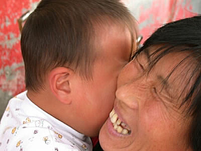 Crying baby and smiling mother, Beijing